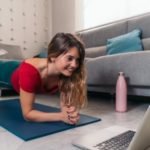 woman training in her house in front of computer